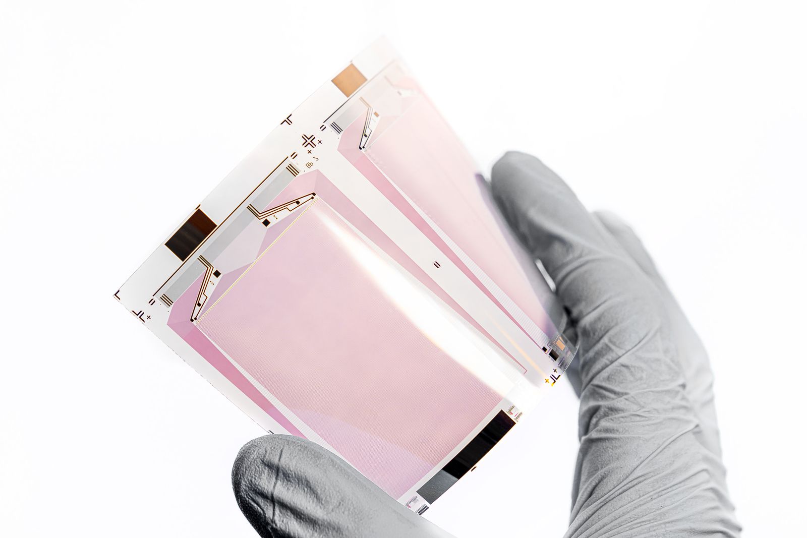 Researcher in cleanroom gloves handling advanced-node semiconductor wafers